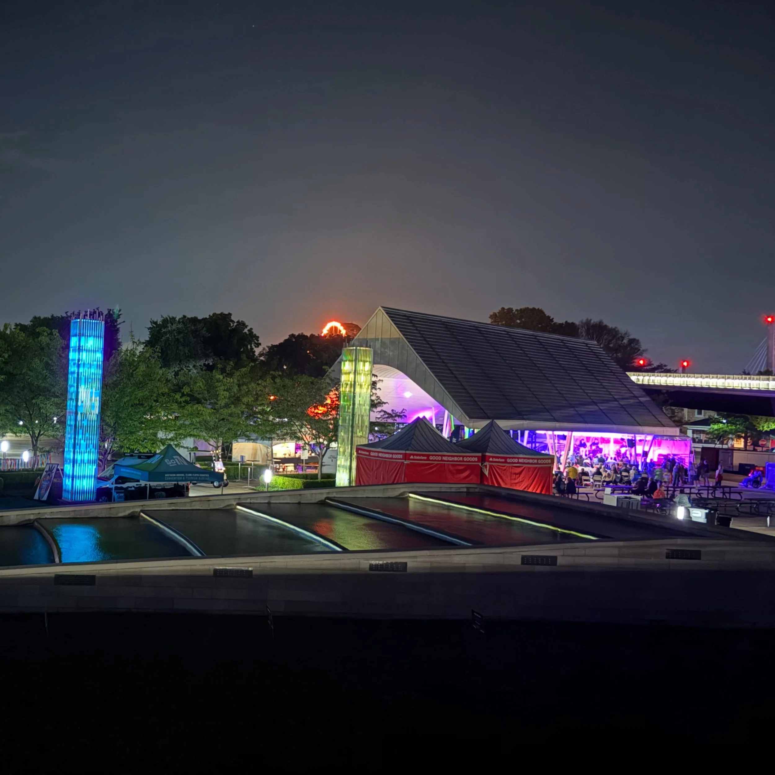 Our beautiful Big Four Station Park is so colorful at night! 🌈🕯️ With the light shards guiding your way into the festival, the Cornbread Hemp Pavilion stage concerts, and Big Four walking bridge in the distance, these photos don&rsquo;t even do it 