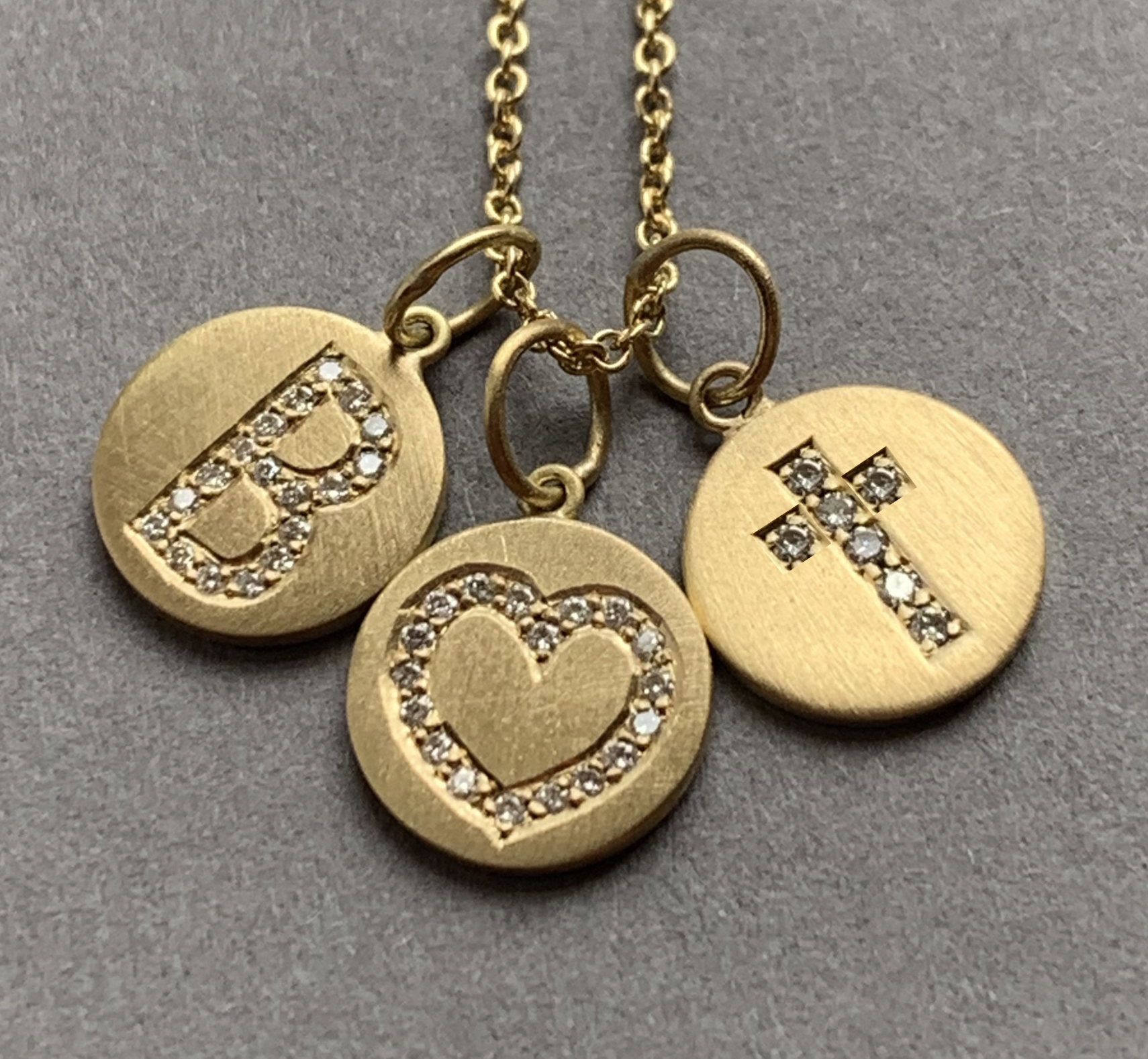 Symbol Gold and diamond pendants