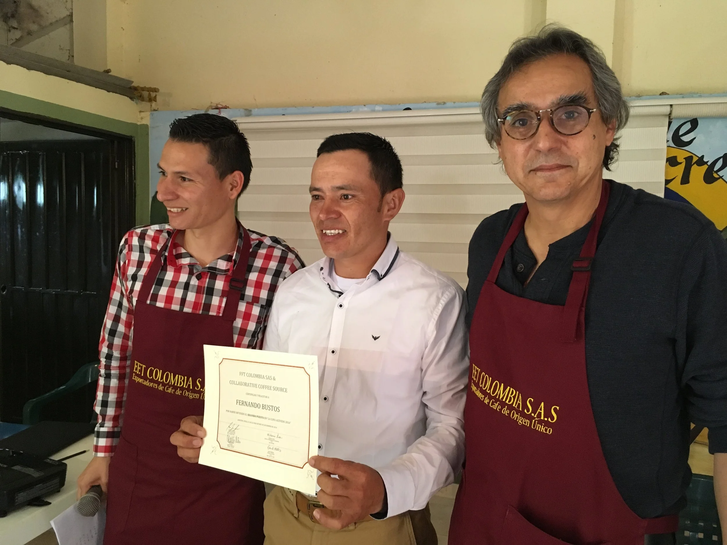 Left to right Eduardo Urquina of Fairfield Trading, Miller Bustos collecting the certificate for his brother Fernando Bustos, and Alejandro Renjifo of Fairfield Trading. 