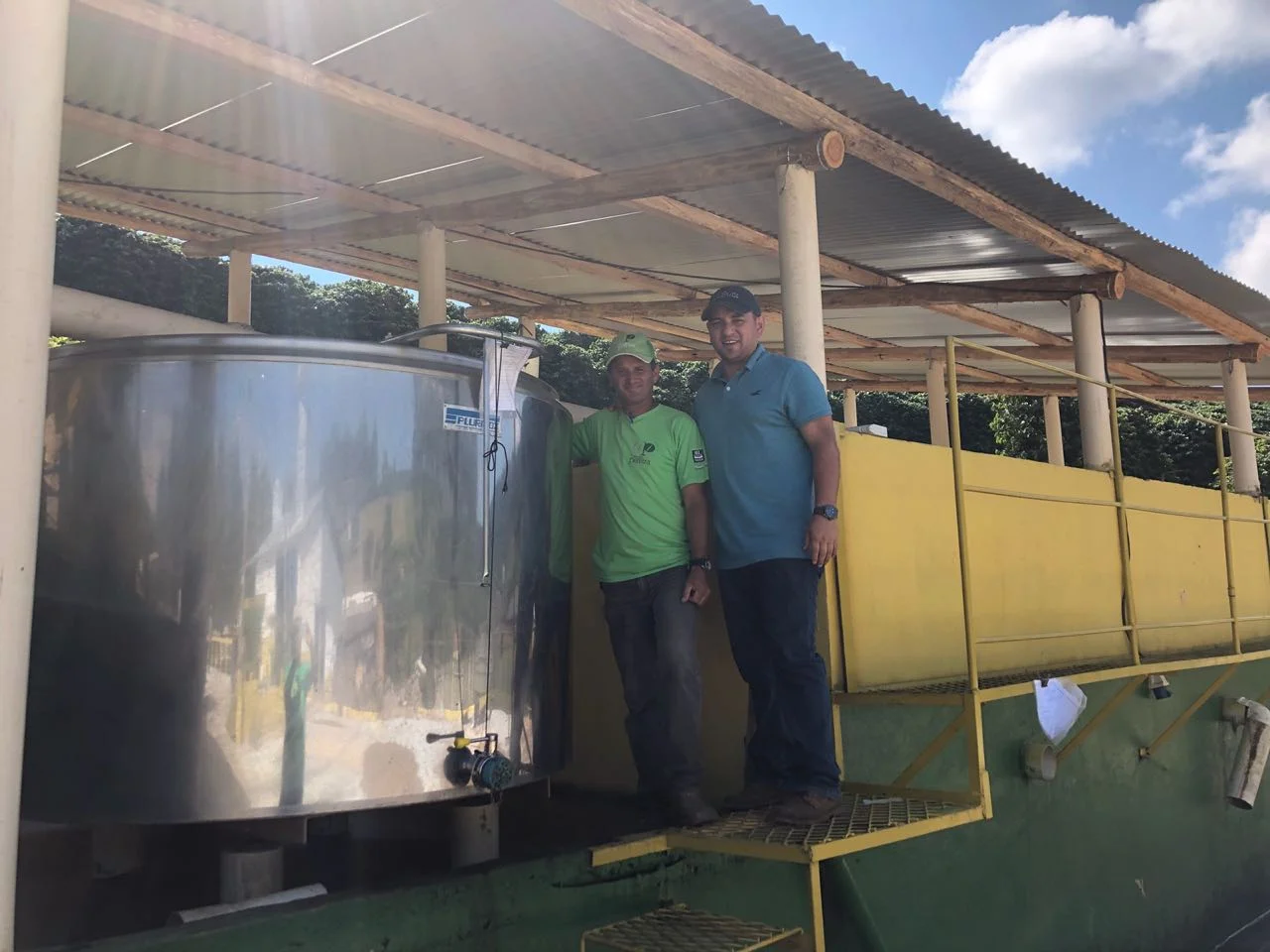 Ivan Solis, fermentation and processing expert from Costa Rica, and Alessandro "Viola", processing manager at Irmas Pereira with the adapted cheese making fermentation tank used for anaerobic processing on several Carmo Coffees farms. 