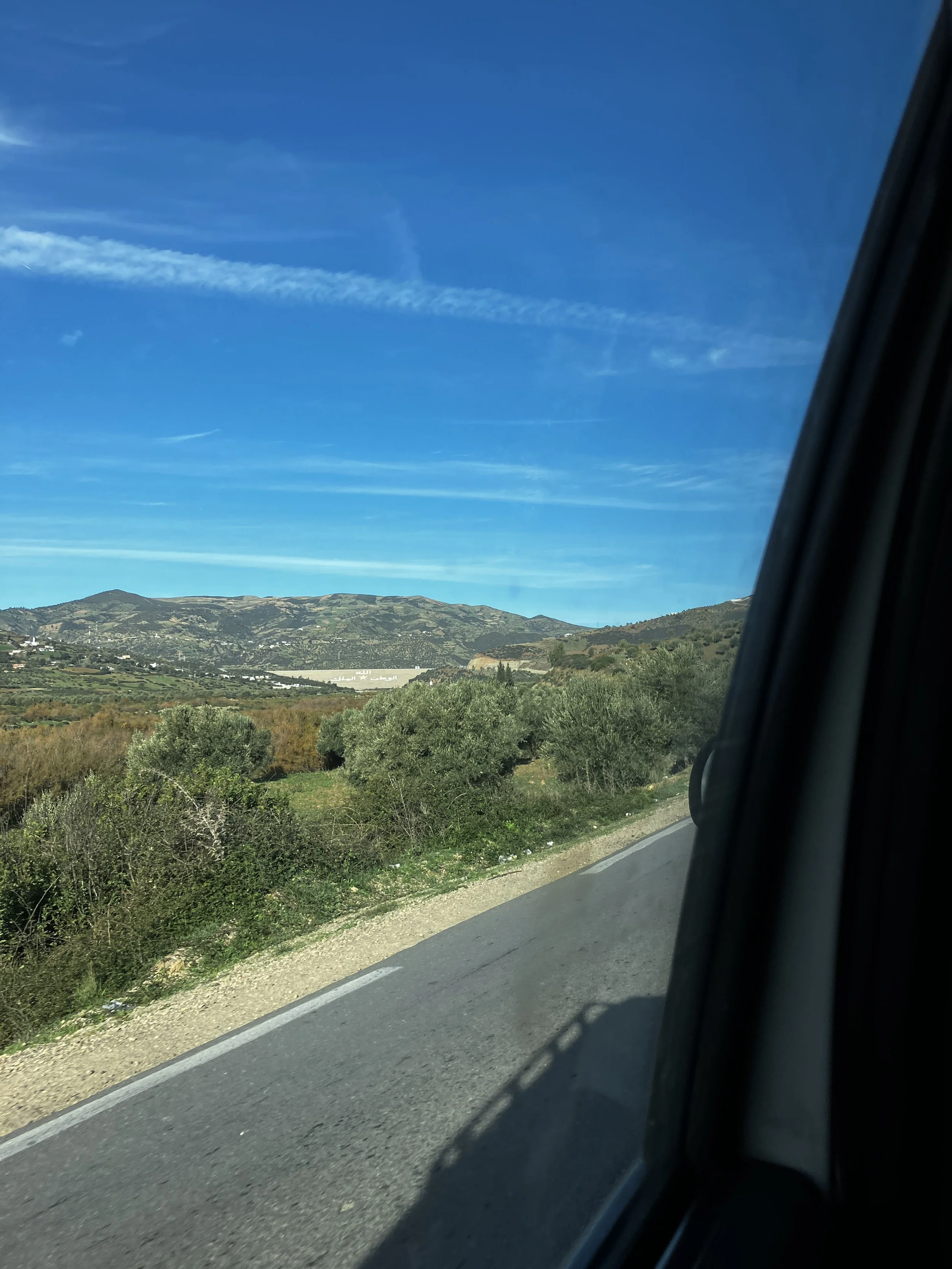   Passing the Chaouen Dam in the grand taxi. The north also faces agricultural issues as the drought continues, though they have access to many mountain springs.   Photo credit: Slon, 2023. 