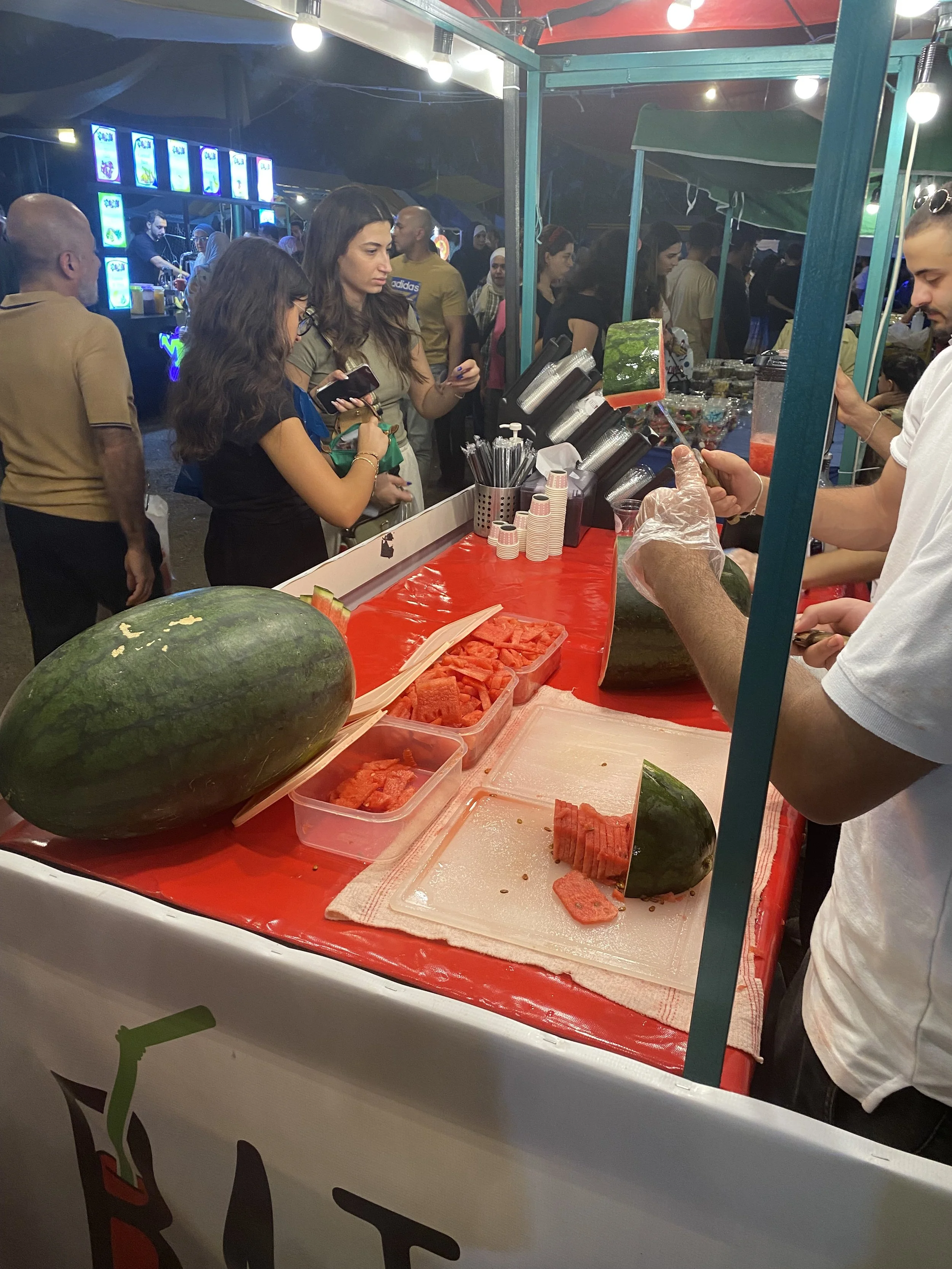   Watermelon vendor in the food section at the end of Souk Jara.  Photo credit: Perricelli, 2024.   