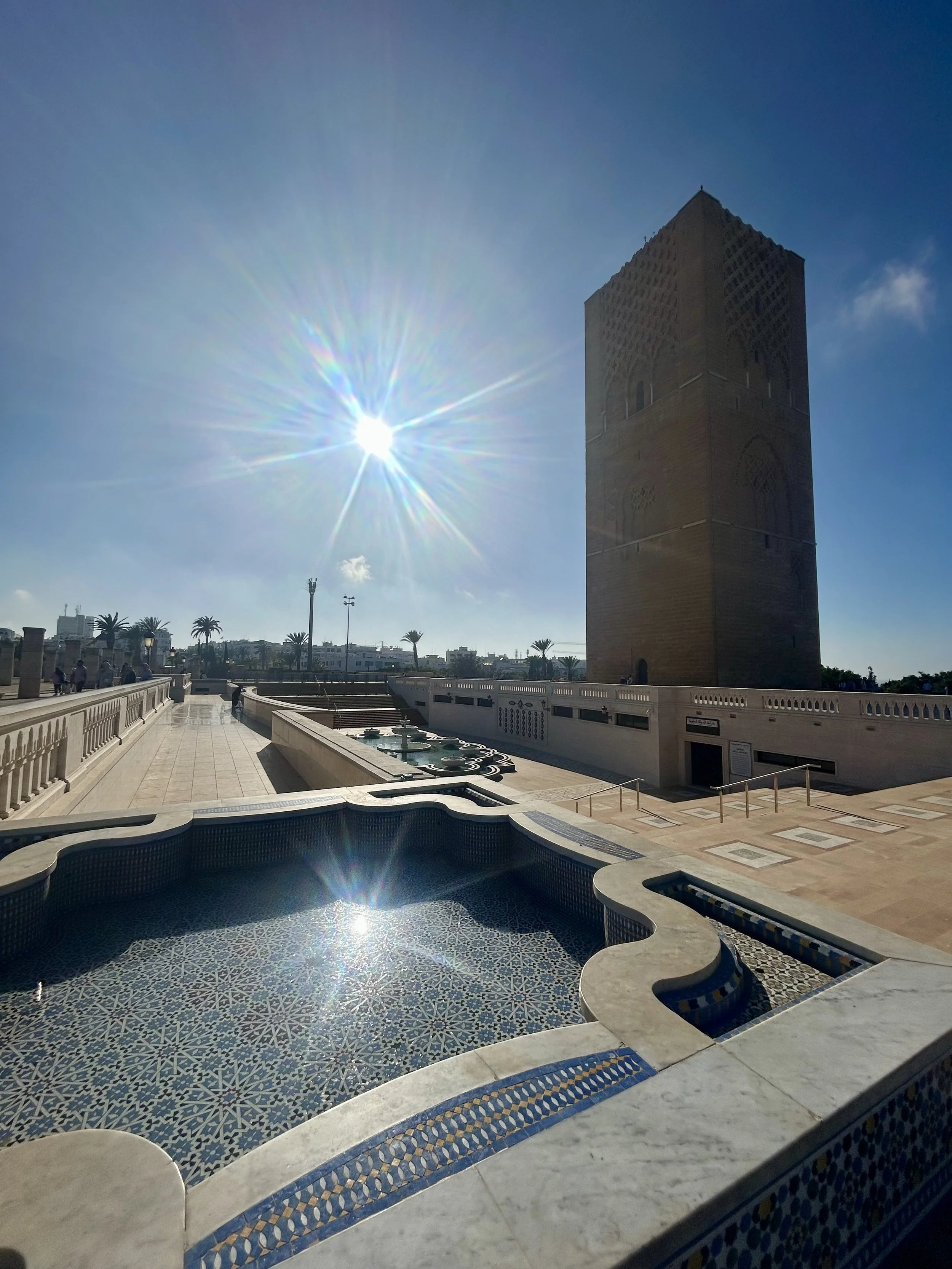 The Hassan tower in Rabat stands to the right of the frame on a very sunny day in Rabat
