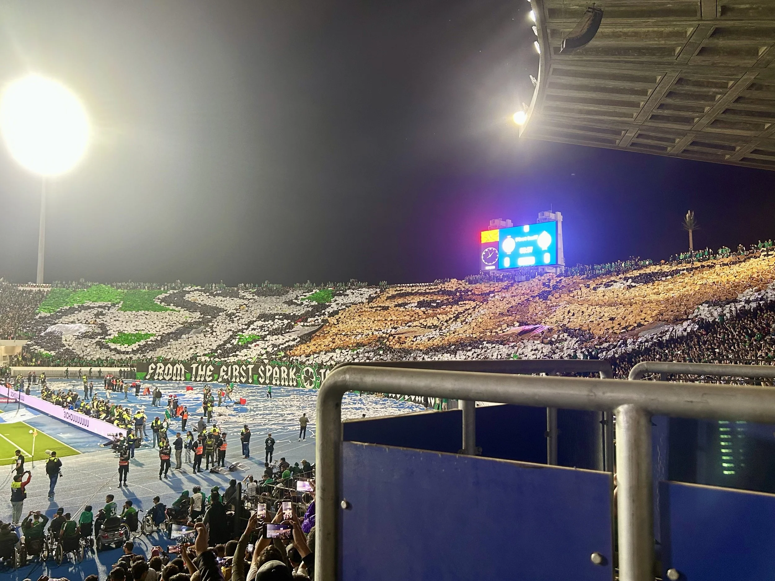 From inside a football stadium packed with people, showing one supporter section