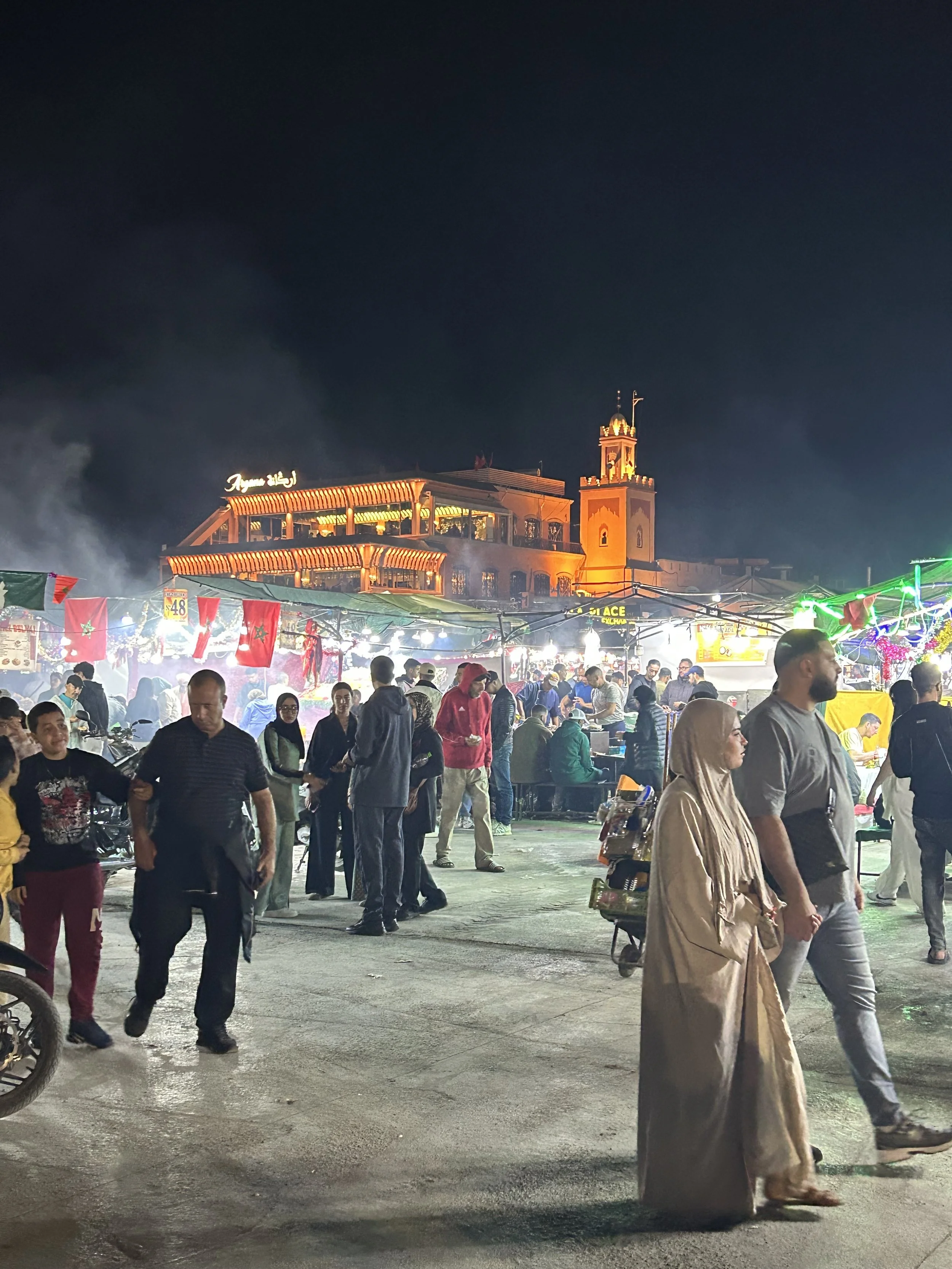 The market in Marrakech is busy with people at night.