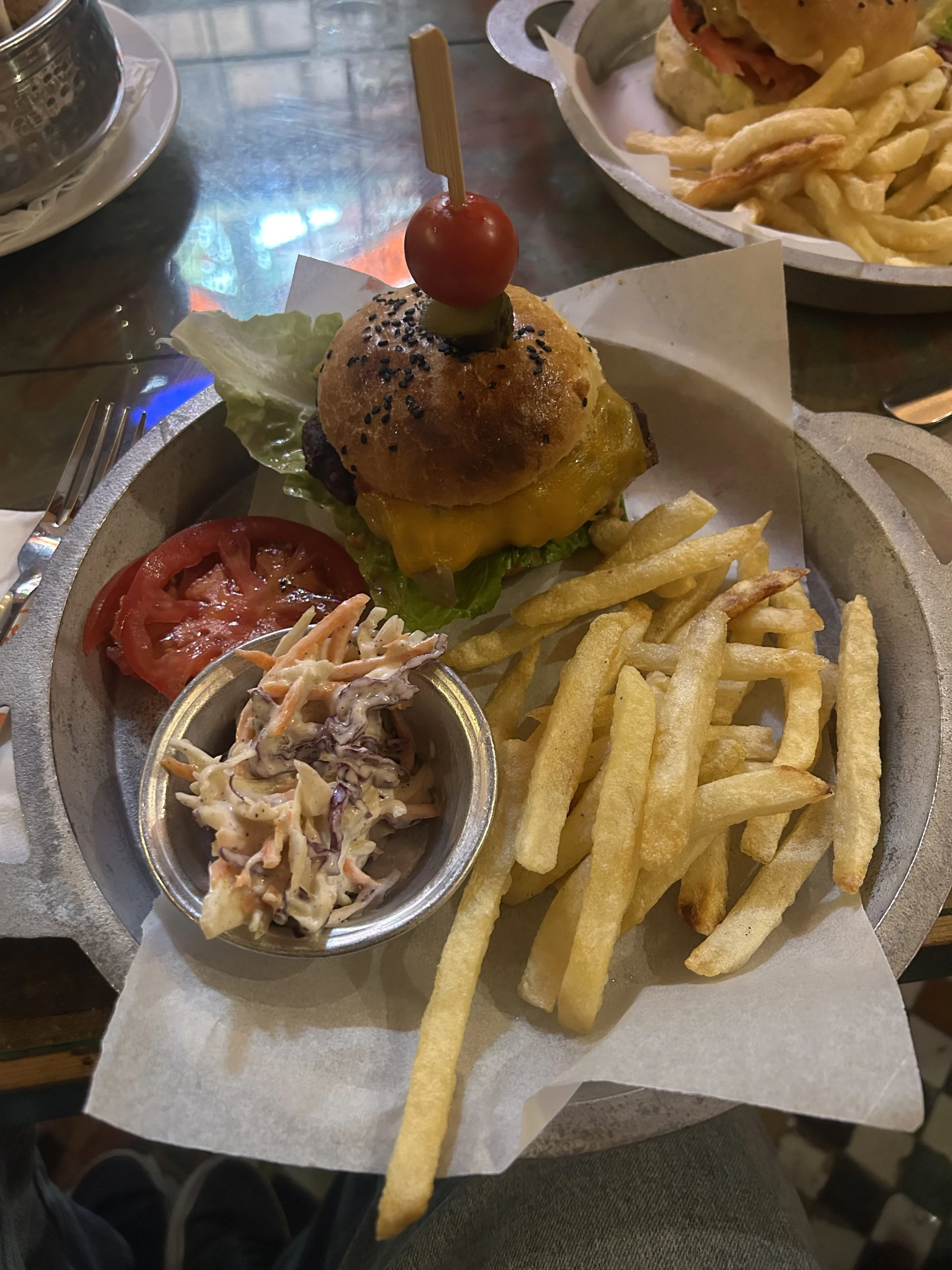 A burger with french fries and coleslaw