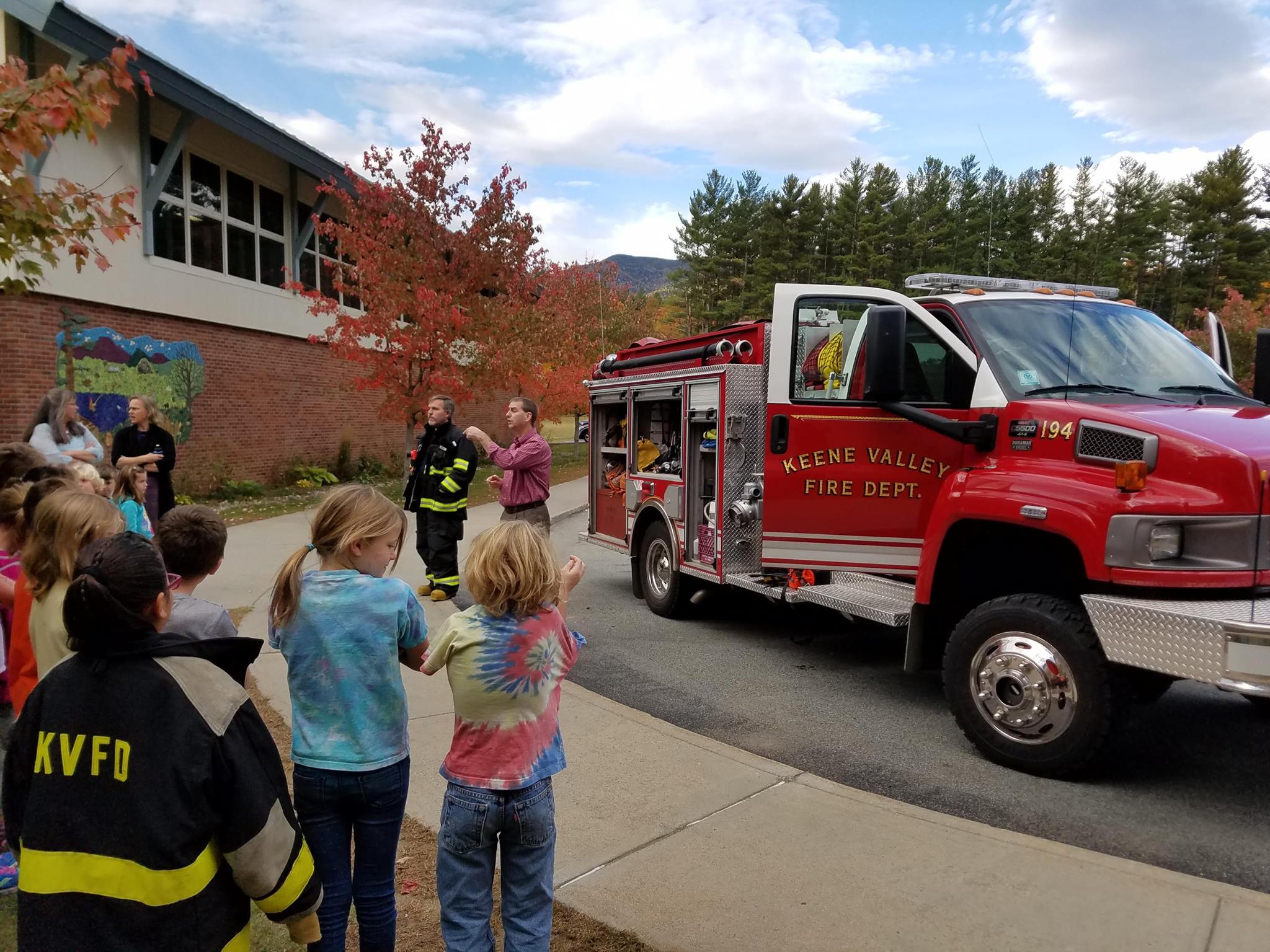 Parents and Faculty introduce themselves as volunteer fire fighters to the local students