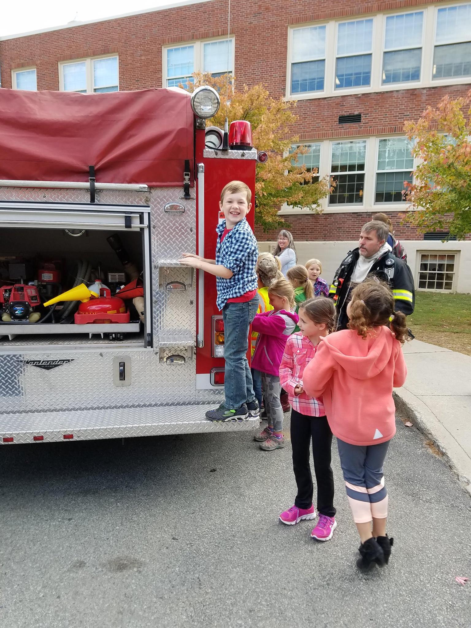 Local students becoming familiar with the fire trucks