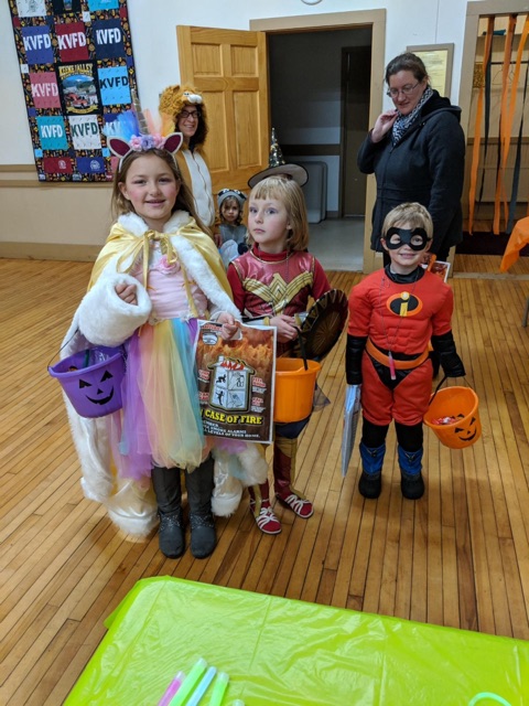 Trick or Treaters enjoying a chance to warm at the Halloween Open House Safe Place