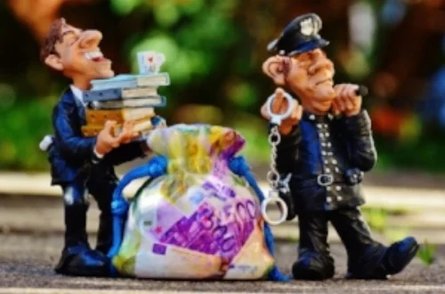 taxes-tax-evasion-police-handcuffs.jpg