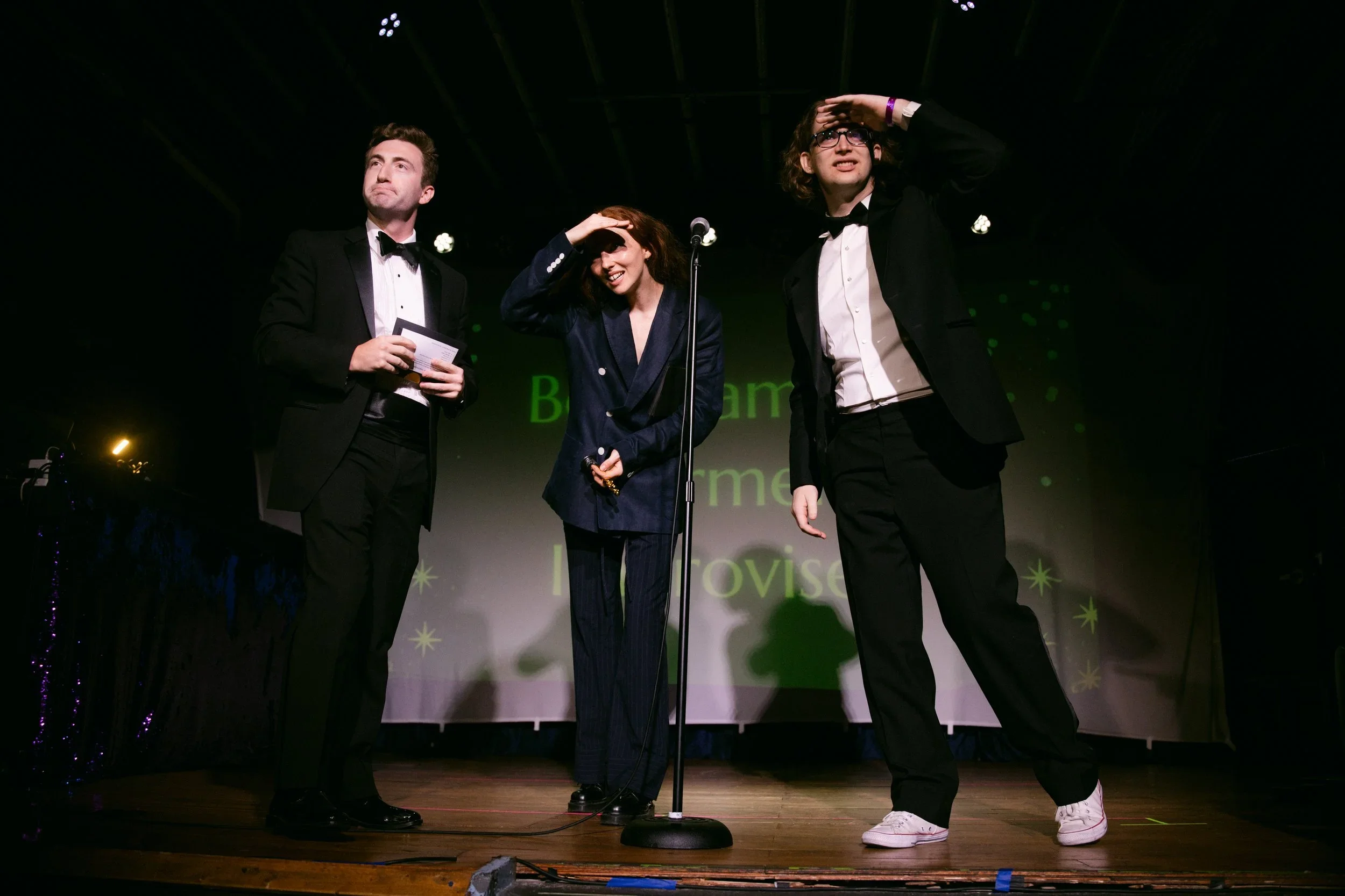 Comedians on Stage in Suits.webp