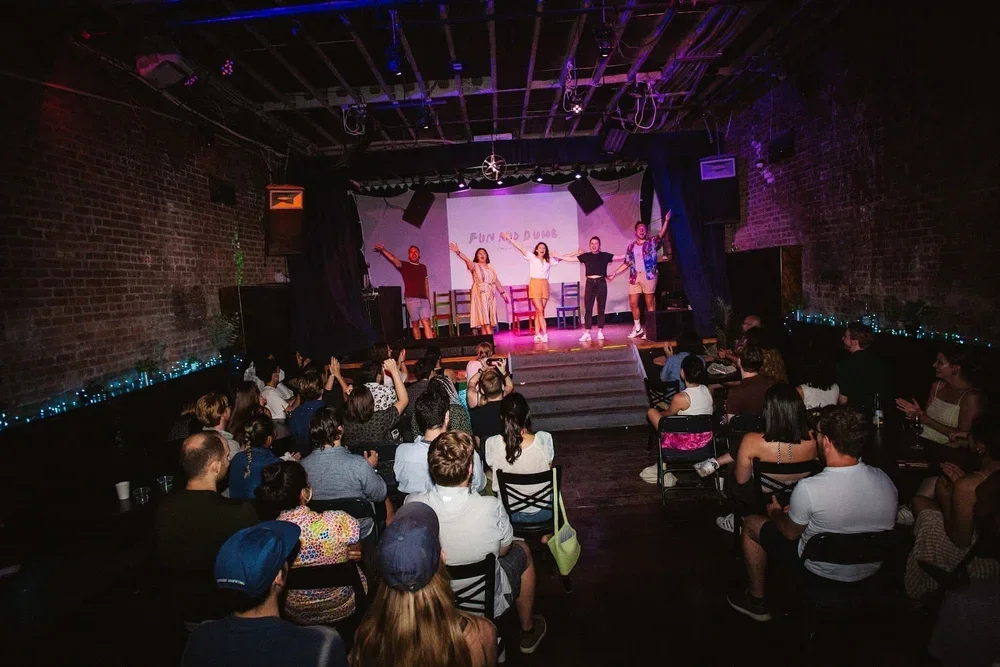 Photo of BCC mainstage featuring performers and a packed crowd.