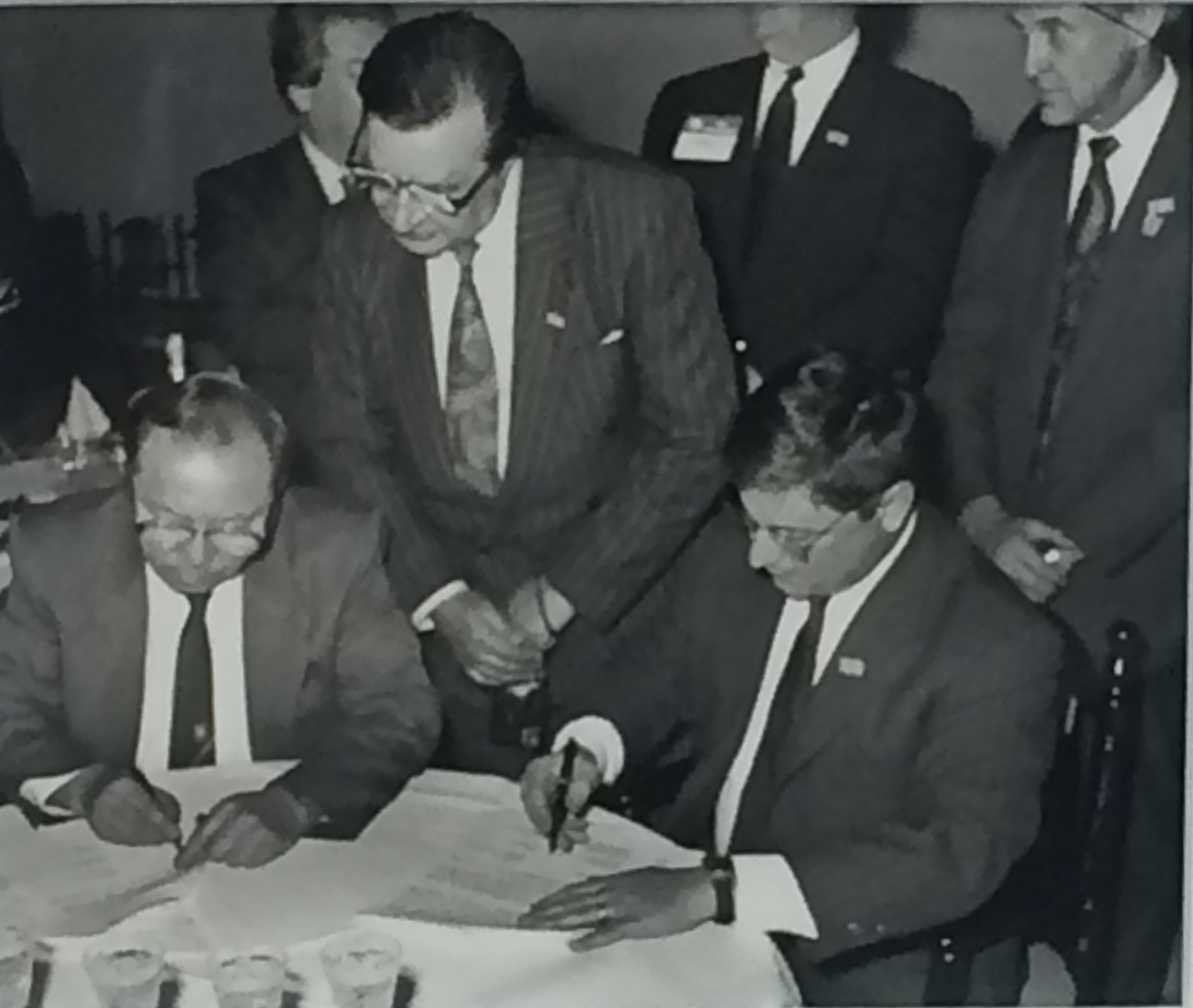  Kazakhstan’s Minister of Finance Yerkeshbay Derbisov and Dan Witt sign an agreement to launch ITIC in March 1993, while State Revenue Administration Director General Marat Ospanov looks on. 