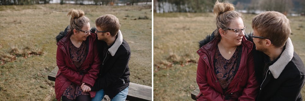 close up of man and woman sat on a bench laughing