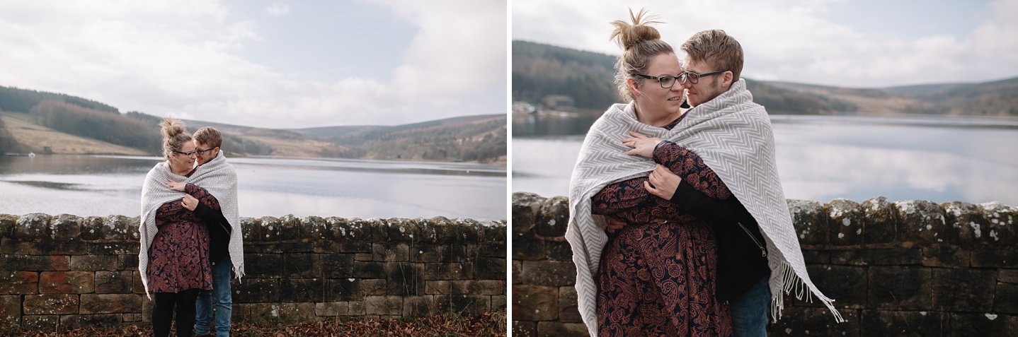 man and woman wrapped in a blanket hugging