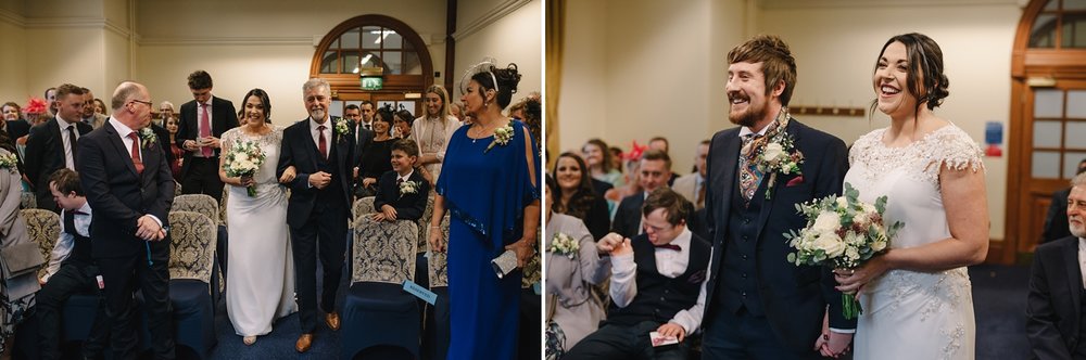 bride walking down the aisle to groom at Sheffield Town Hall