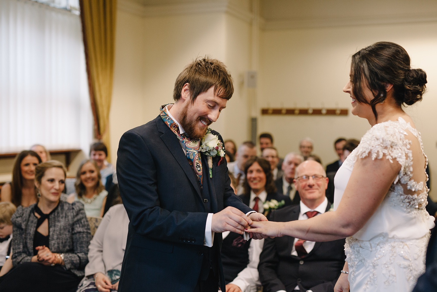 bride and groom exchanging wedding rings at Sheffield Town Hall Wedding