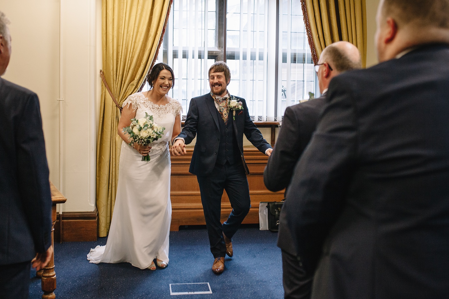 Bride and groom walking down the aisle at Sheffield Town Hall