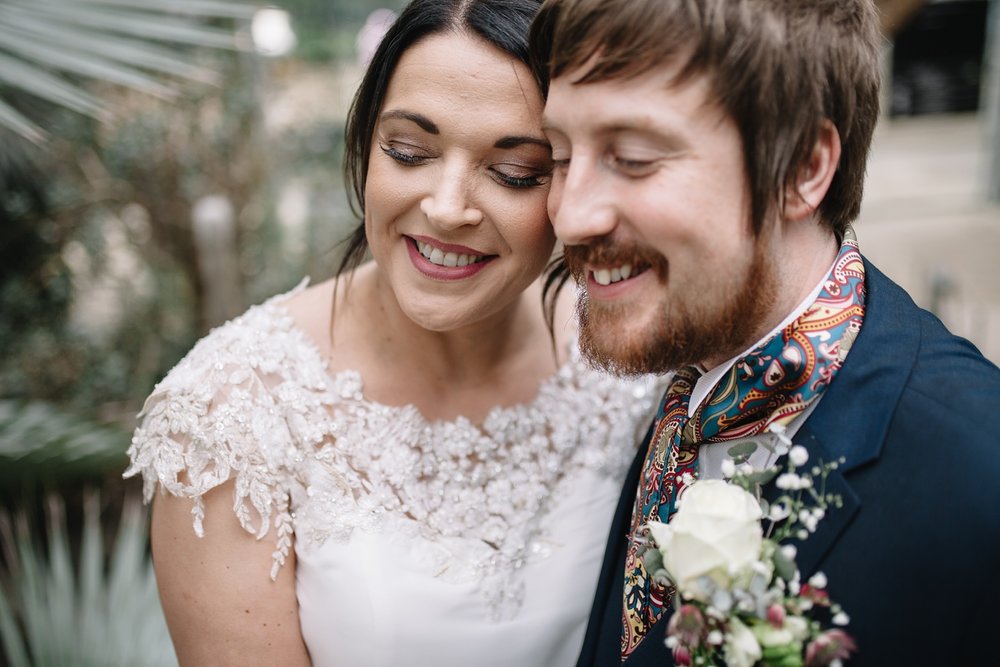 close up of bride and groom smiling