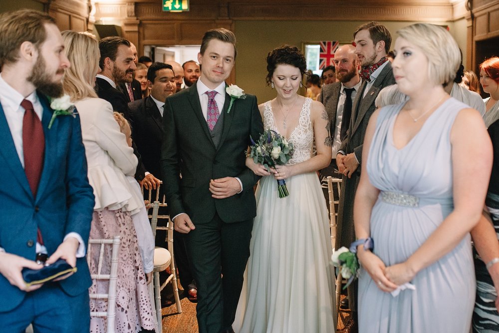 bride and groom walking down the aisle together for the start of the ceremony at Whirlowbrook Hall