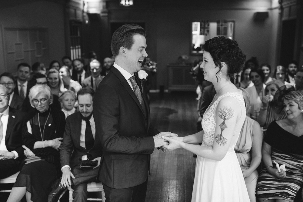 Bride and groom exchanging wedding rings at Whirlowbrook Hall