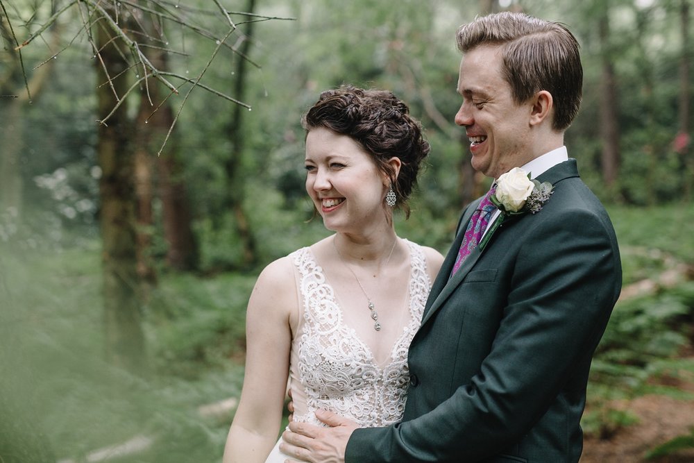 close up of bride and groom laughing in the woods at Whirlowbrook Hall