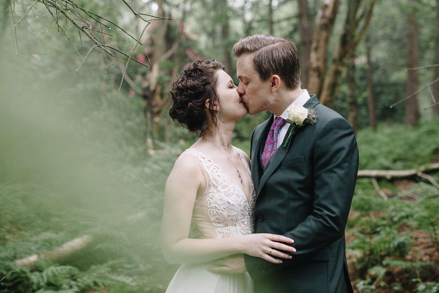 close up of bride and groom kissing at Whirlowbrook Hall woods