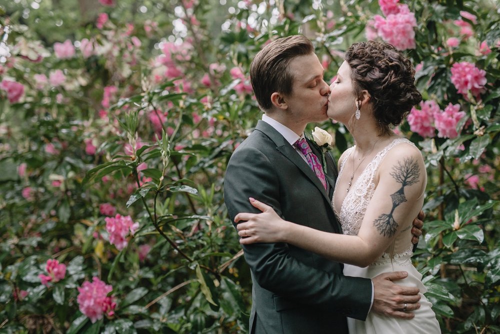 bride and groom kissing in the woods at whirlowbrook hall wedding