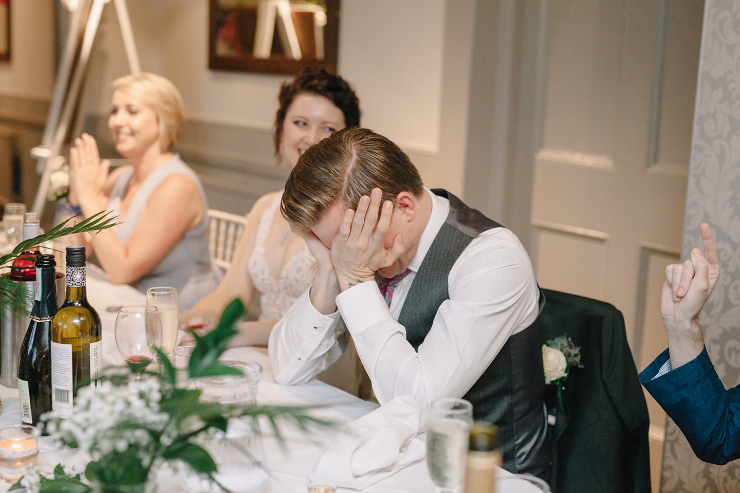 groom with head in hands embarrassed during speeches at Whirlowbrook Hall wedidng