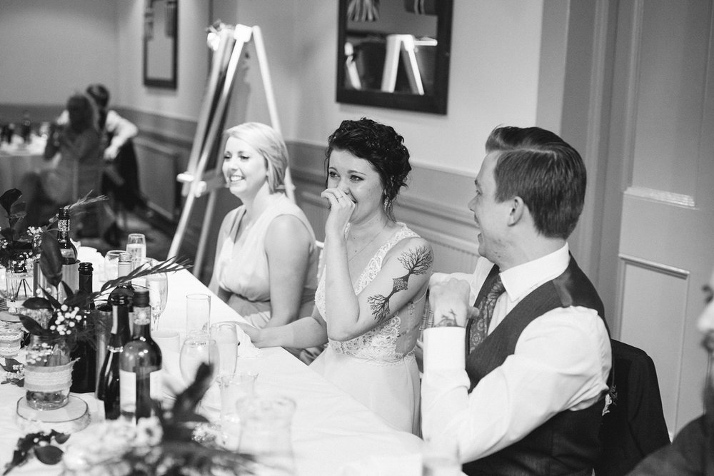 black and white photo of bride laughing at speeches at Whirlowbrook hall wedding