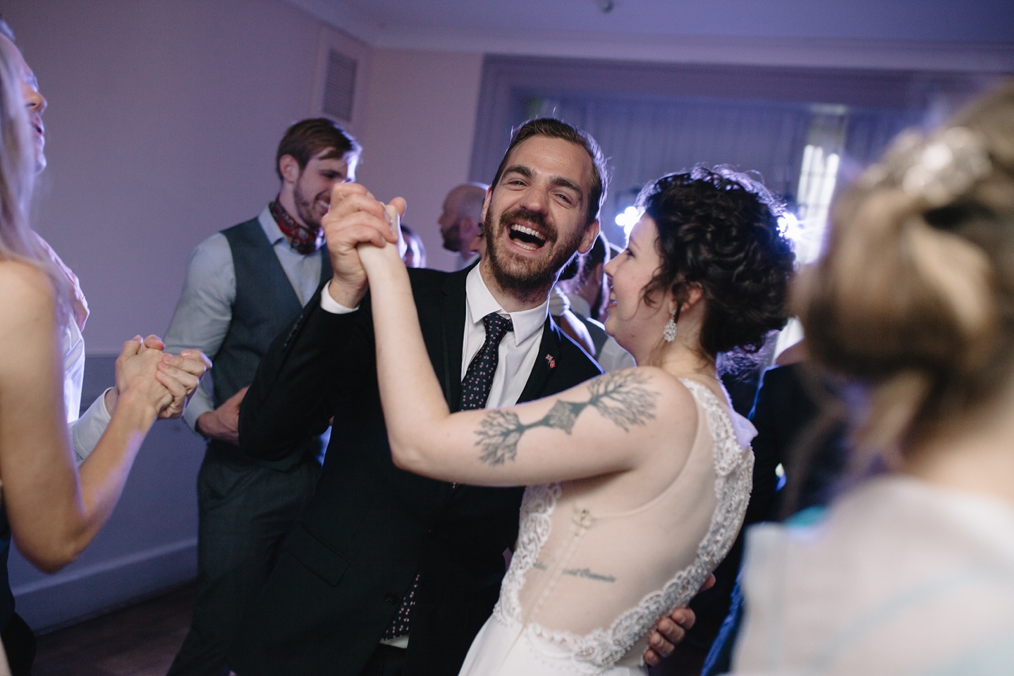 bride and guest dancing and laughing on the dance floor at Whirlowbrook Hall