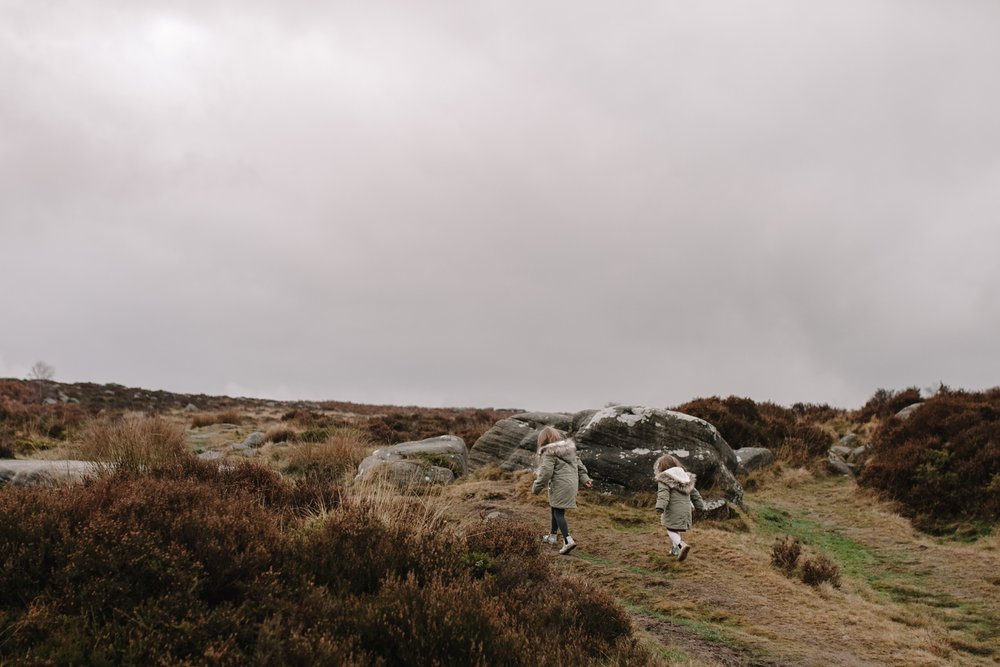 two little girls running through the moors of Padley Gorge Sheffield