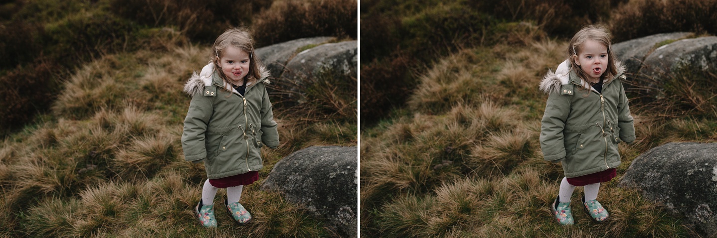 little girl stood pulling funny faces at the camera