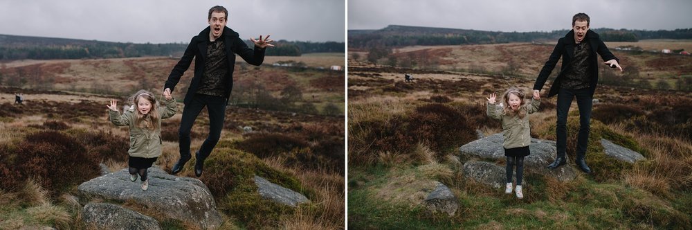 little girl and dad jumping off a big rock