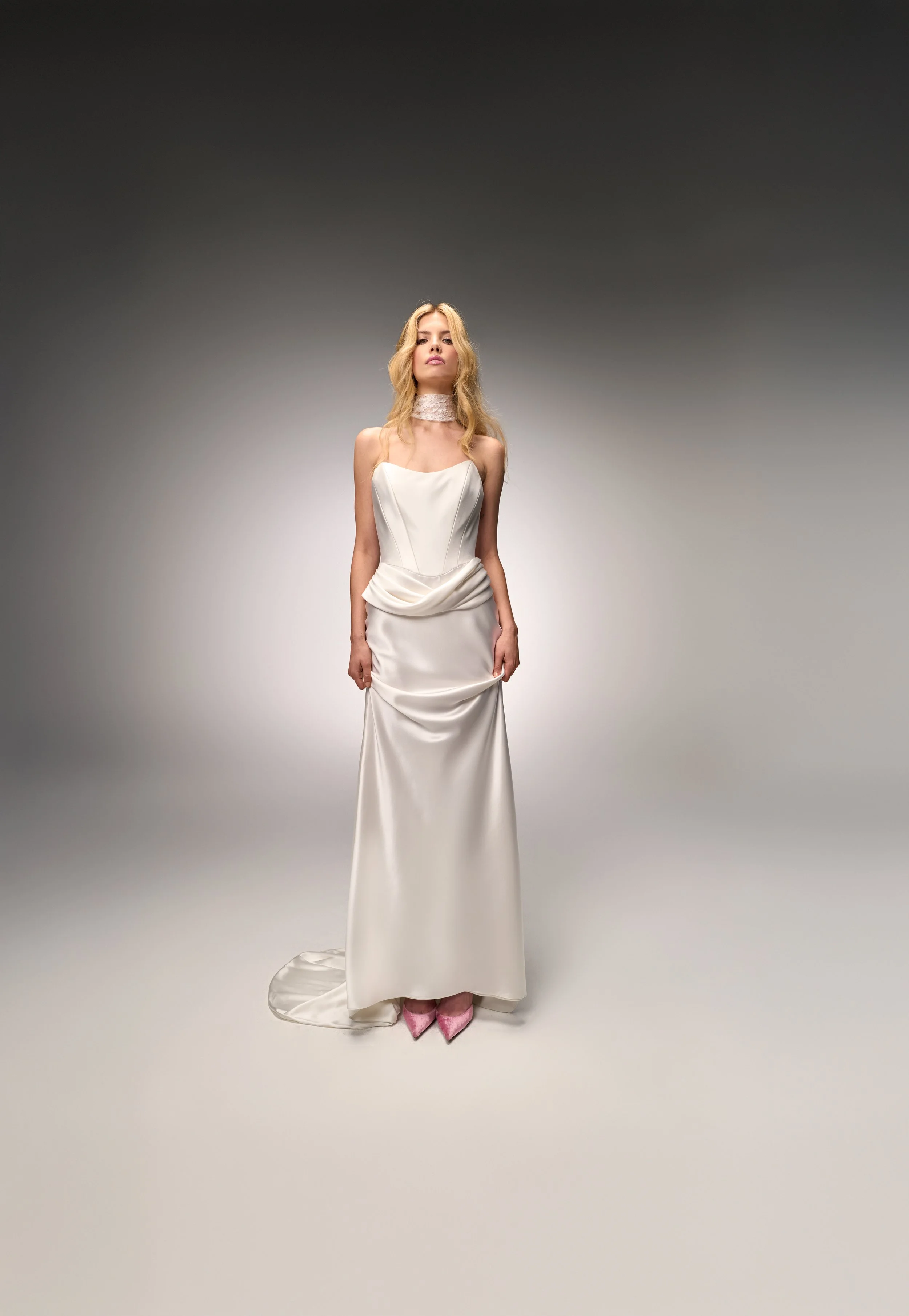 Front view of the Deneuve gown showcasing the strapless neckline and sculptural hip peplum