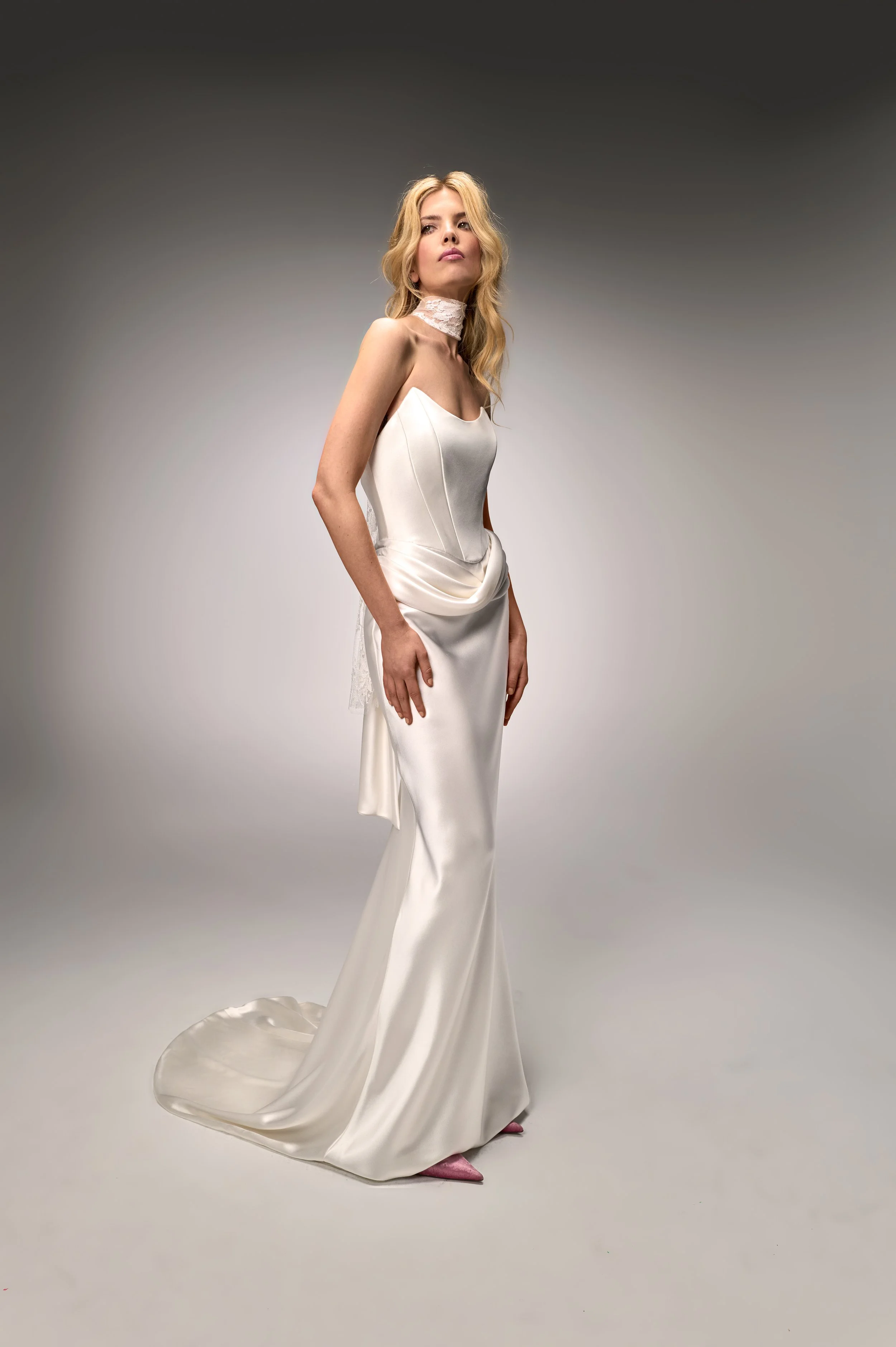 Side profile of the Deneuve gown highlighting the charmeuse fabric and draped design