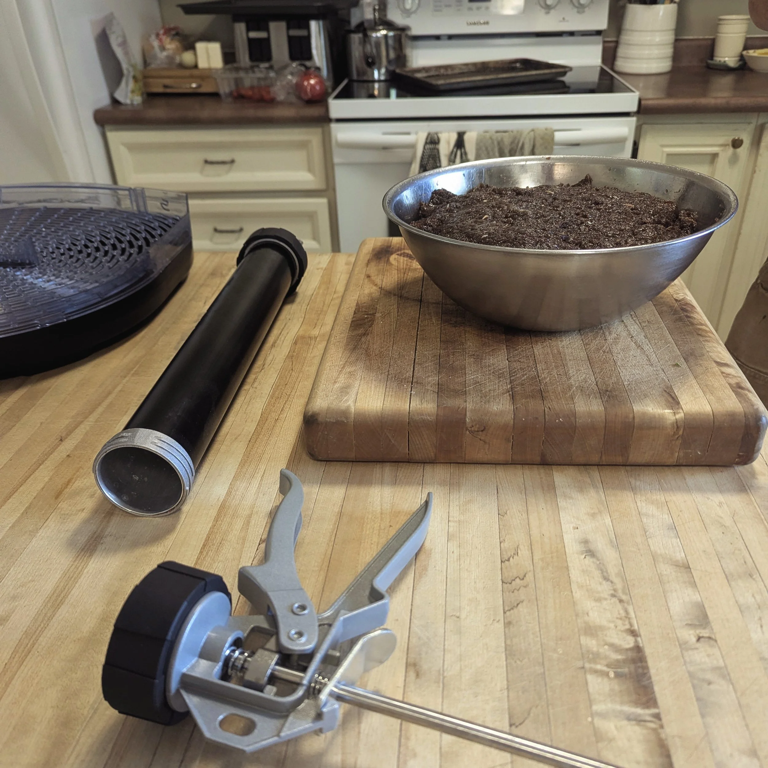 a bowl of meal with food processing equipment in a kitchen