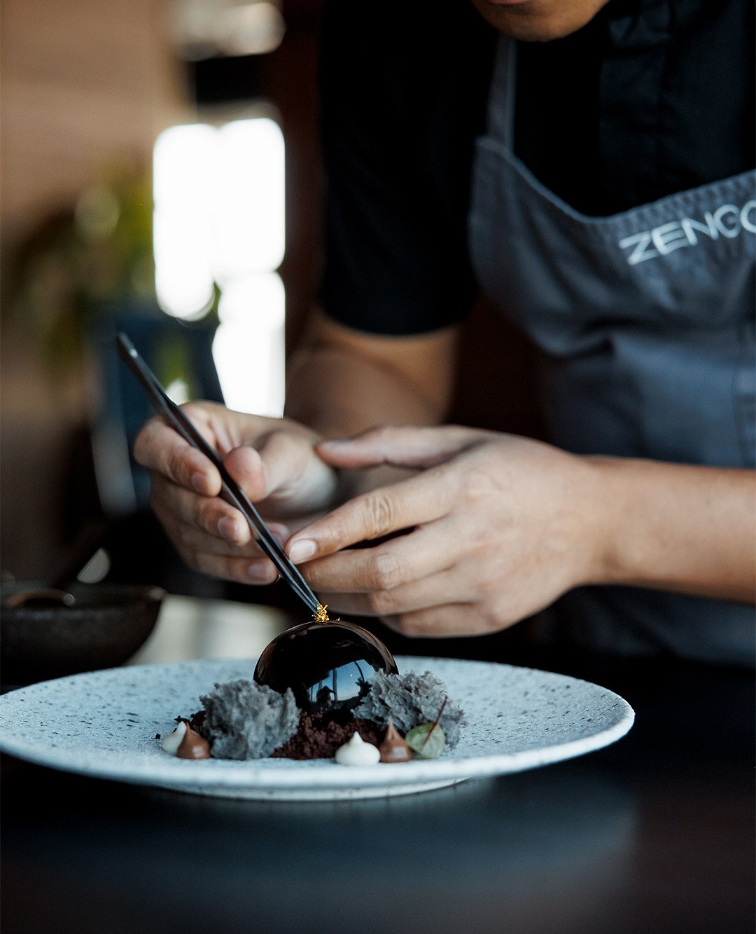 Our Black Pearl dessert is a tribute to Qatari elegance, meticulously crafted with layers of milk chocolate mousse, surprising miso caramel, and delicate sesame sponge.