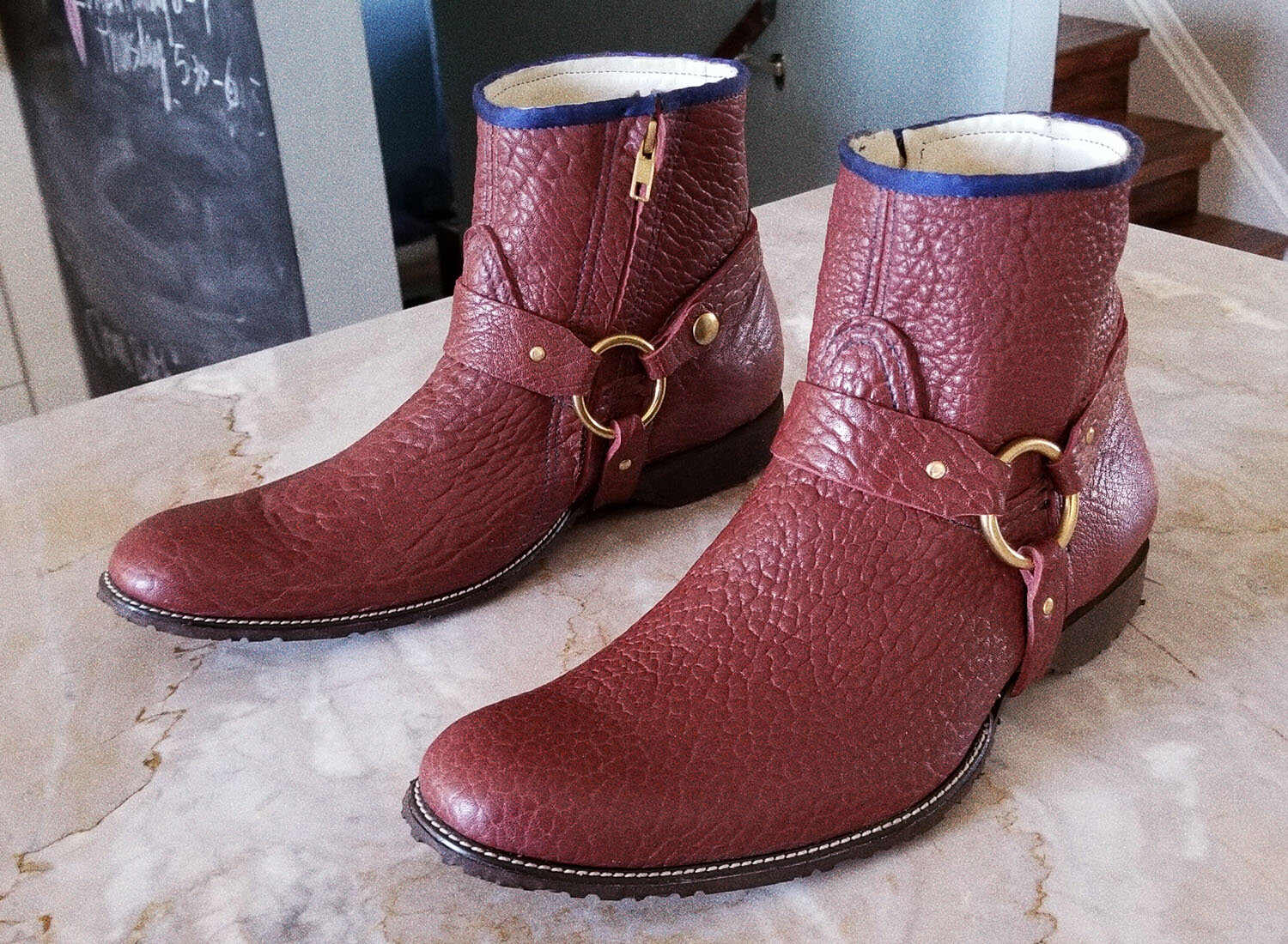Pebbled maroon calfskin leather boot.