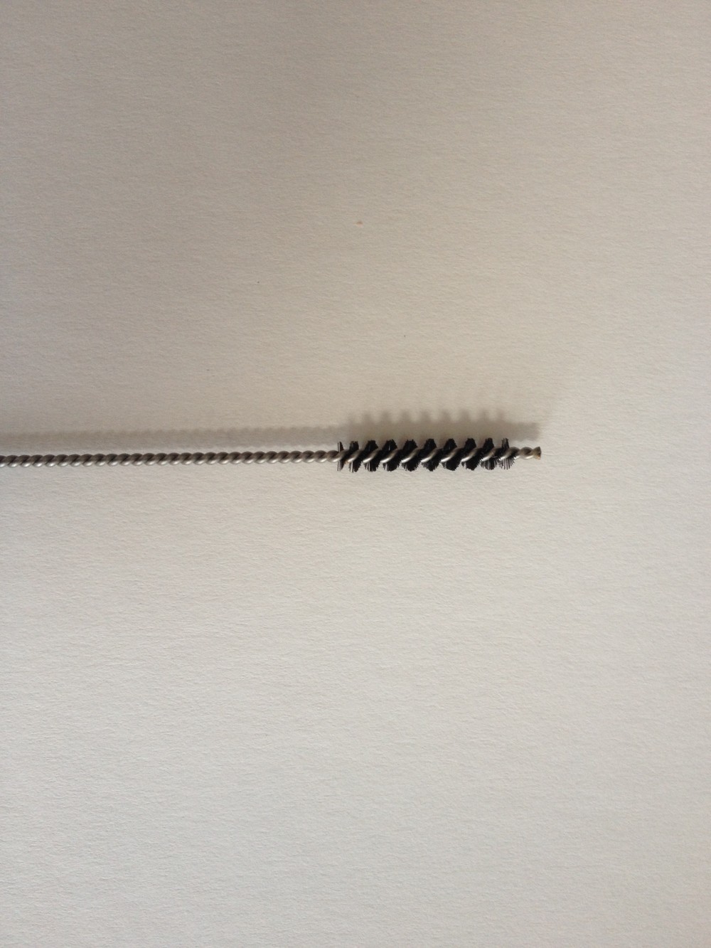 tiny brush for cleaning milk frother hose on coffee machine