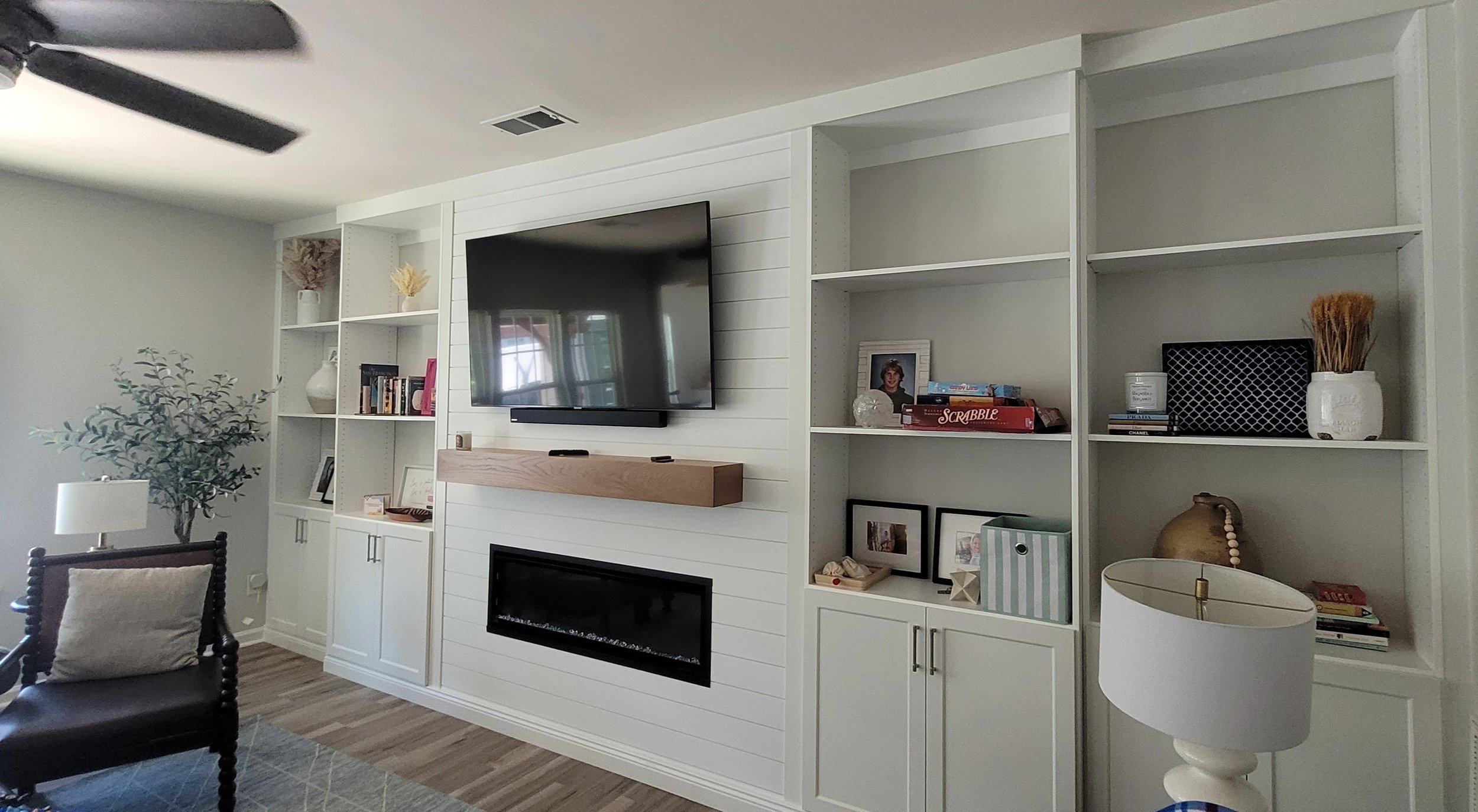 Custom family room built-in with shaker cabinets and shiplapdesigned and installed by NC Visionz in Denver, NC.