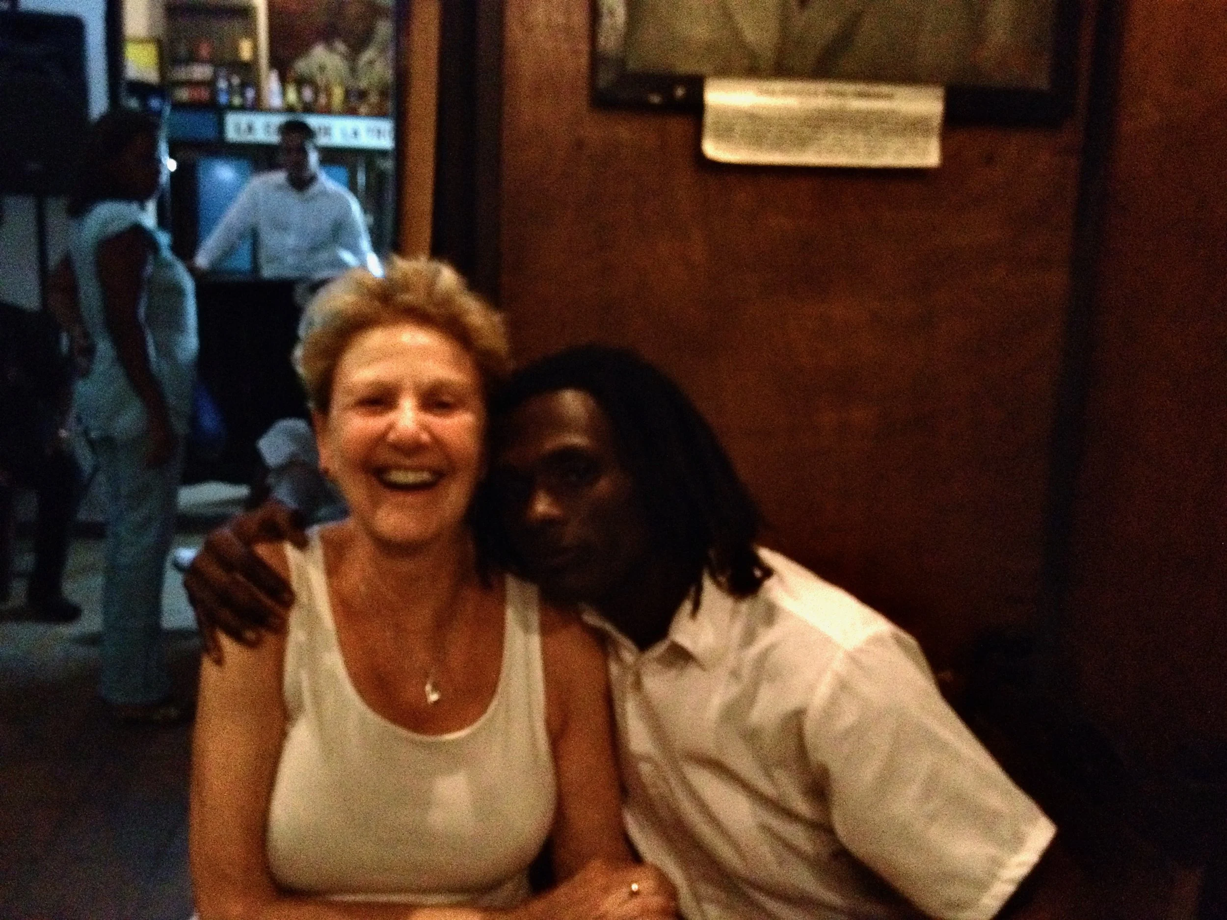 Sheila laughing with a beautiful man hugging her side