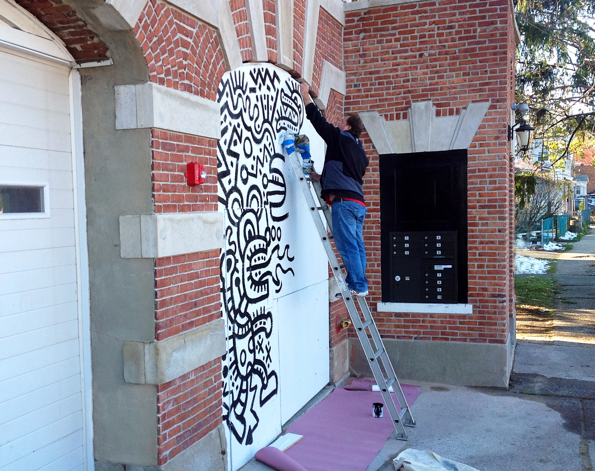  New Jersey artist Dan Fenelon paints a mural at the Firehouse Gallery and Artist Lofts 