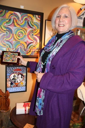  Artist Bev Cohn with original collage and jewelry box with reproduction tile 