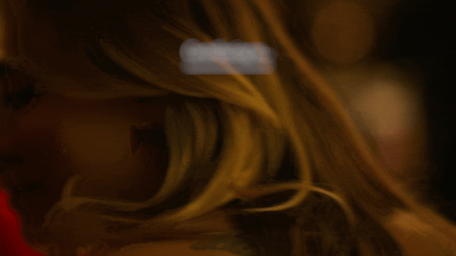 Close-up of a plant with yellow and green leaves, illuminated by warm lighting.