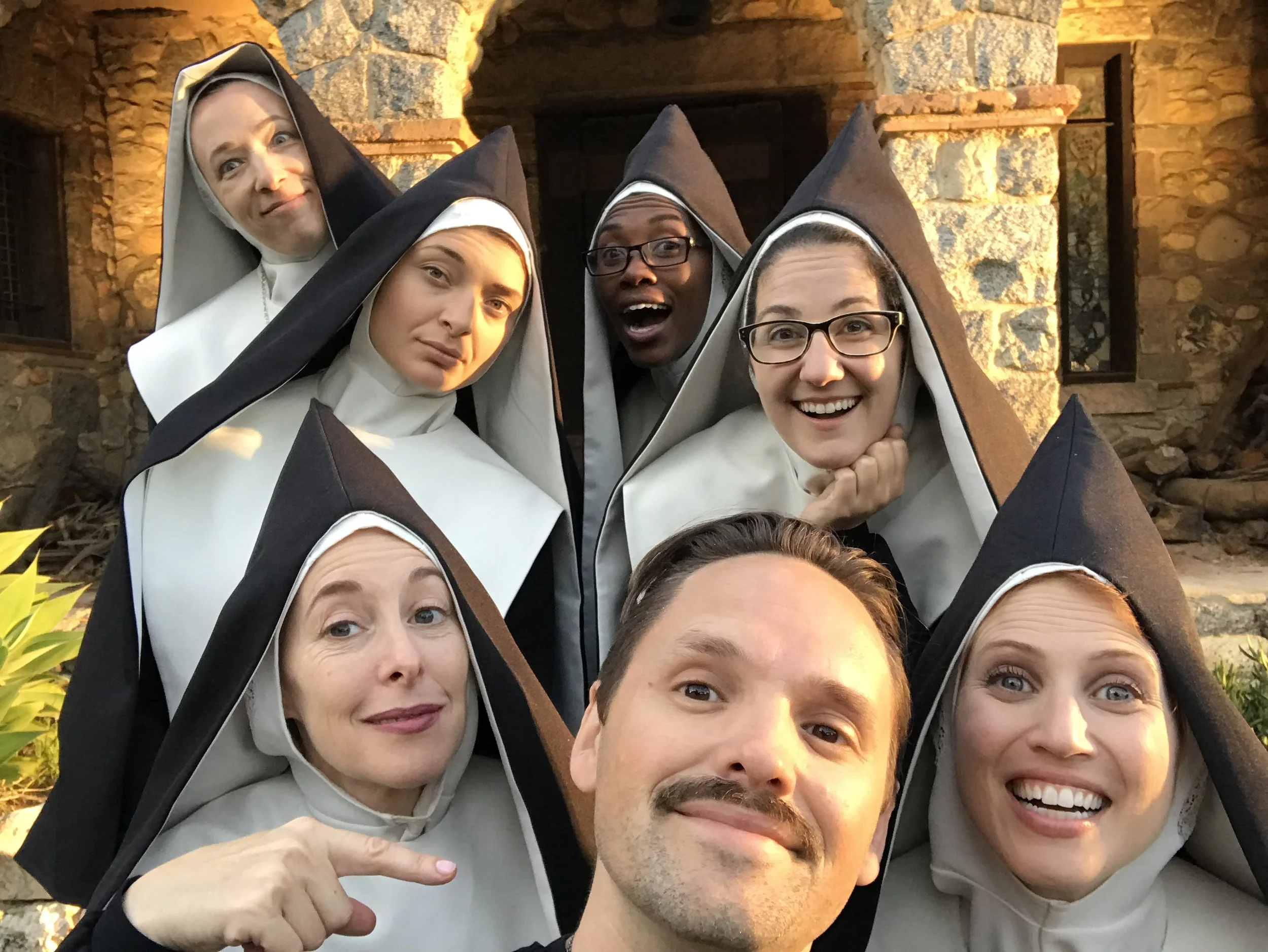 A group of seven people dressed as nuns taking a selfie outside a stone building.
Good Omens Amazon Hal Kirkland Director Chattering Order of St Beryl. 