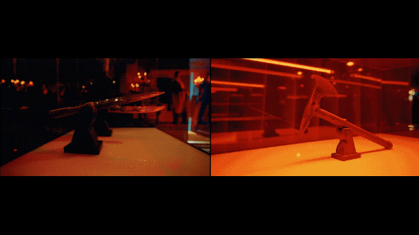 Two points of view of a lightsaber toy displayed on a table, with a dimly lit background featuring red and orange lighting and people in the distance.