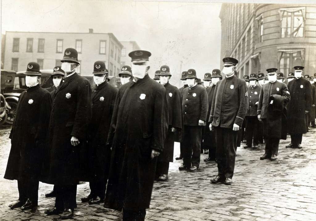 Police officers in Seattle are pictured in this December 1918 photo wearing masks made by the Seattle Chapter of the Red Cross during the influenza epidemic.