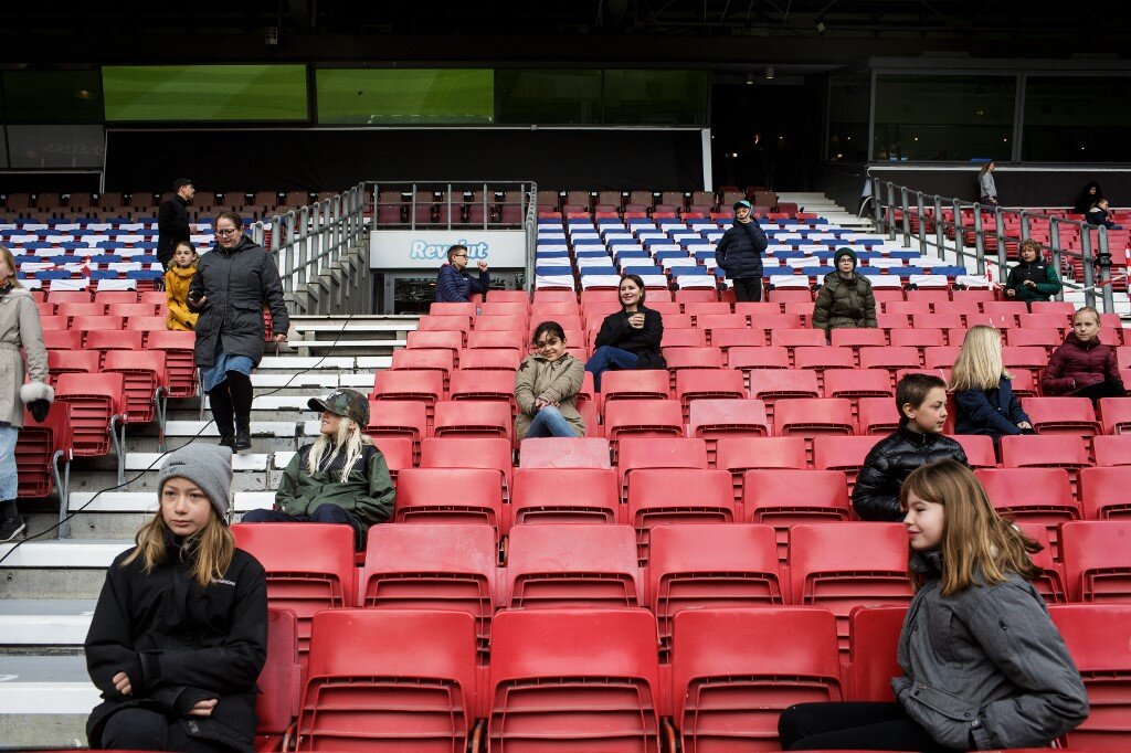 Pupils in Denmark take their socially distanced seats in the stands before an open-air-class held at the Telia Parken stadium due to Covid-19 restrictions. 