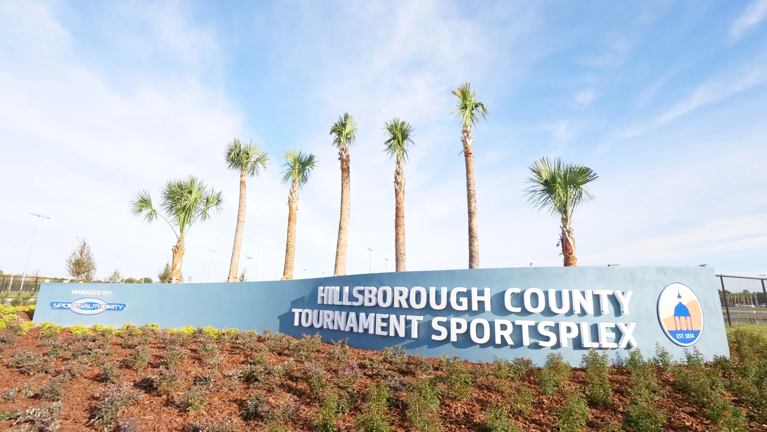Palm trees line the Hillsborough County Tournament SportsPlex sign. 